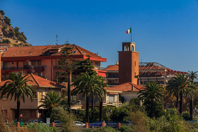 Buildings in city against clear sky