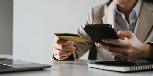 Midsection of woman using mobile phone