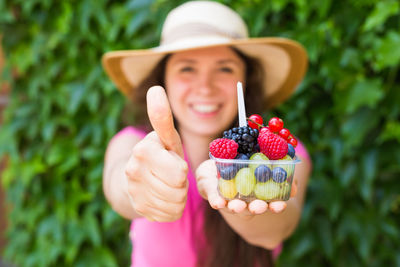 Portrait of woman holding apple