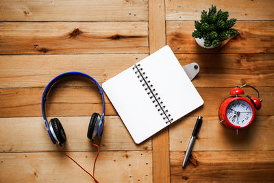 Directly above shot of blank book with headphones on table