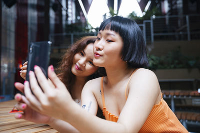 Portrait of beautiful woman holding mobile phone