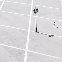 High angle view of woman walking on road