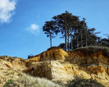 Low angle view of rock formations against sky