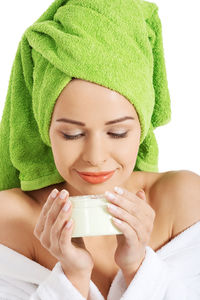 Woman holding cream box against white background