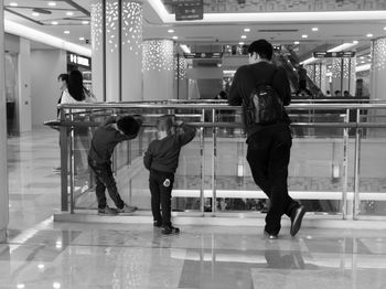 Rear view of people walking in shopping mall