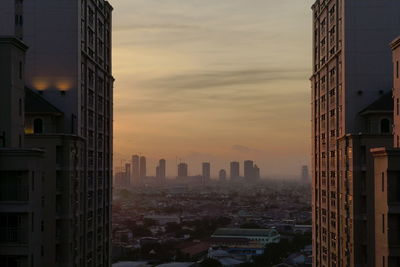 Modern buildings in city during sunset