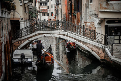 People in boat against canal