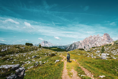 Backpacker on hiking trails in the dolomites, italy.