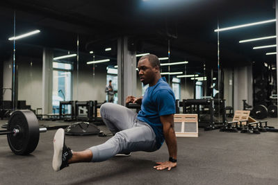 Side view of man exercising in gym