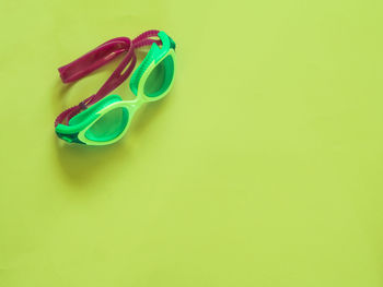 High angle view of multi colored pencils on green background