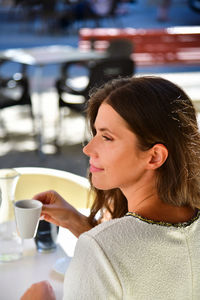 Portrait of woman drinking coffee at cafe