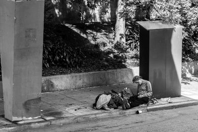 People sitting on footpath