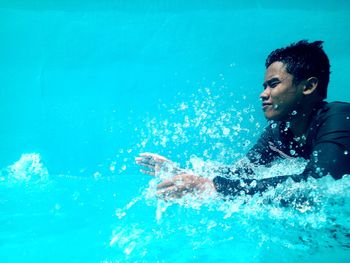 Young man swimming in pool
