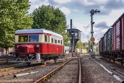 Historical train bus on railroad track against sky