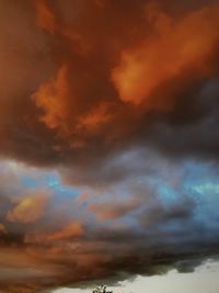 Low angle view of storm clouds in sky during sunset