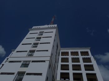 Low angle view of modern building against blue sky