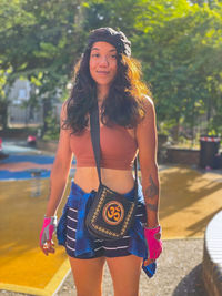 Portrait of beautiful young woman standing in city