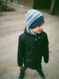 High angle view of boy standing on road