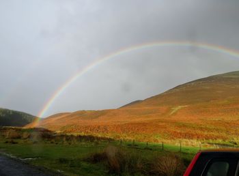 Scenic view of rainbow over mountains