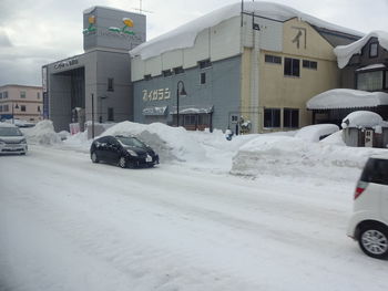 Car on street against buildings in city