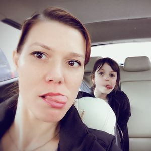 Portrait of beautiful woman sitting in car