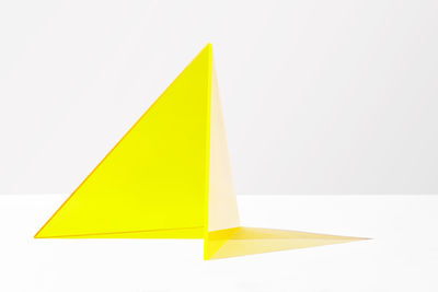 Close-up of yellow paper over white background