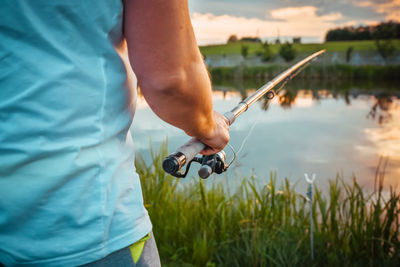 Rear view of man fishing in water