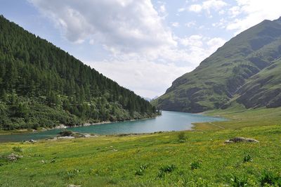 Scenic view of land and mountains against sky