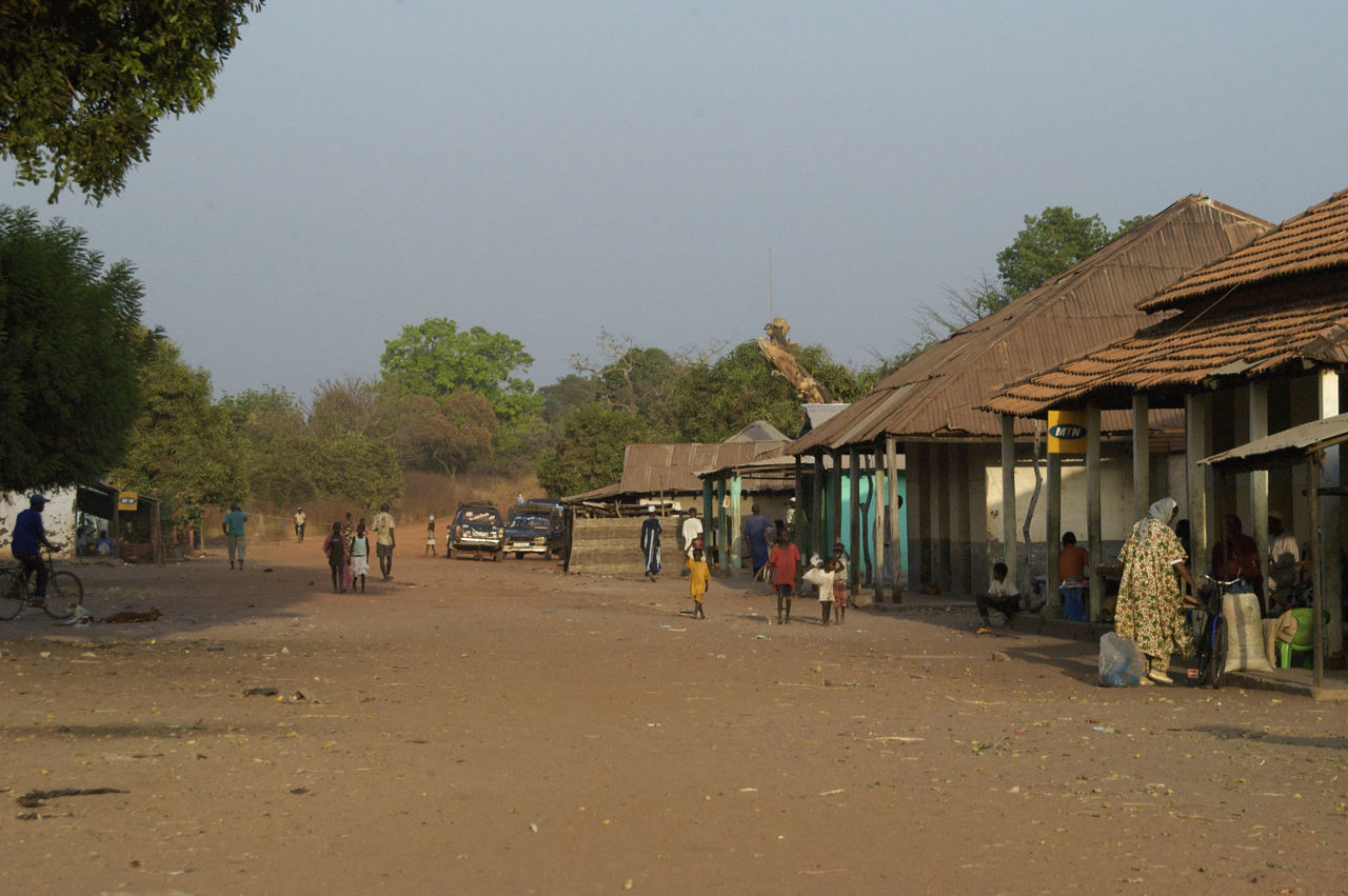 PEOPLE ON STREET AGAINST SKY