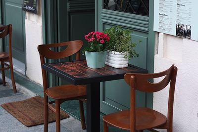 Chairs arranged by table at sidewalk cafe