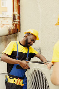 Side view of man working at construction site