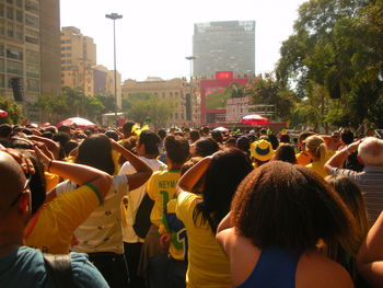 Rear view of people on street in city