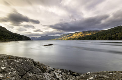 Scenic view of lake and mountains against sky