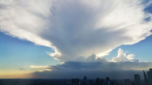 Cityscape against cloudy sky