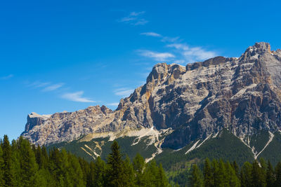 Low angle view of mountain range against blue sky