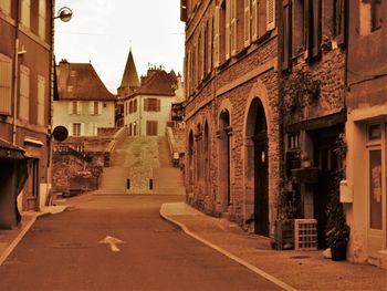 Empty street leading towards church in city