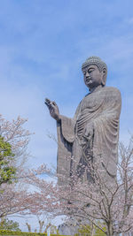 Low angle view of statue against sky