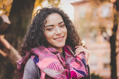 Portrait of smiling young woman standing outdoors