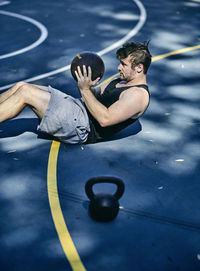 Young man exercising on basketball court