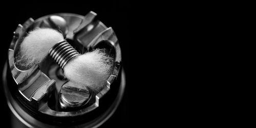 Black and white, monochrome shot of single micro coil with cotton in rebuildable dripping atomizer