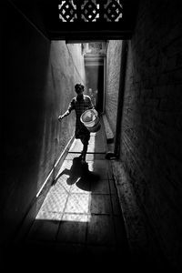 Rear view of man standing in corridor