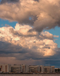 Low angle view of buildings against dramatic sky