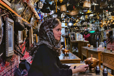 Side view of woman looking away in store