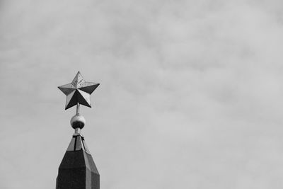 Low angle view of cross sign against sky