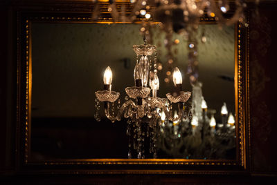 Close-up of illuminated chandelier hanging at home