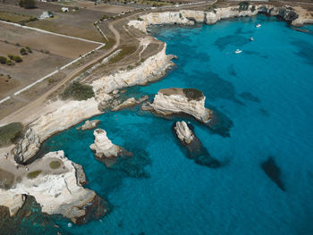 High angle view of rocks on sea shore