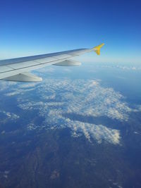 Aerial view of airplane flying in sky