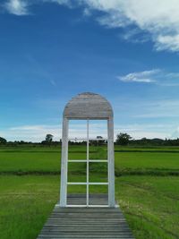 Built structure on field against sky