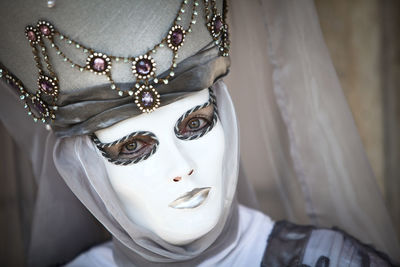 Portrait of person wearing venetian mask 