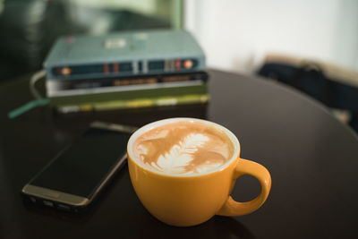 Close-up of coffee cup on table